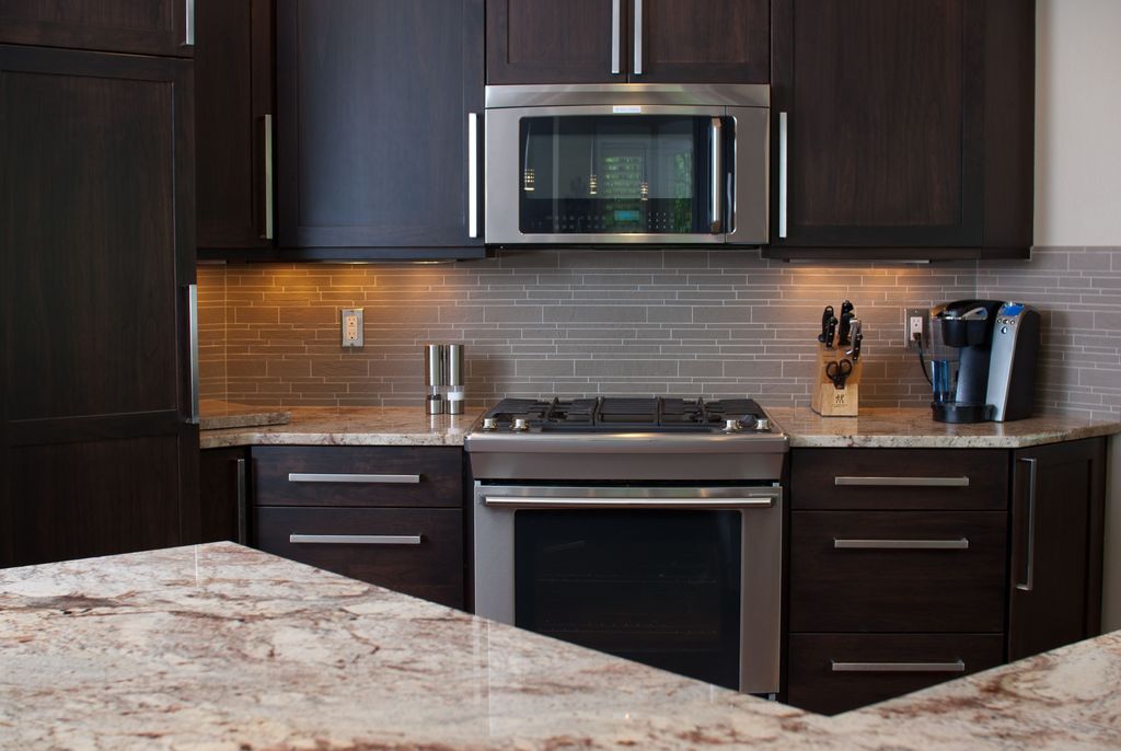 Contemporary Kitchen with Flat panel cabinets, Standard height, One-wall, Flush, Kitchen island, Complex granite counters