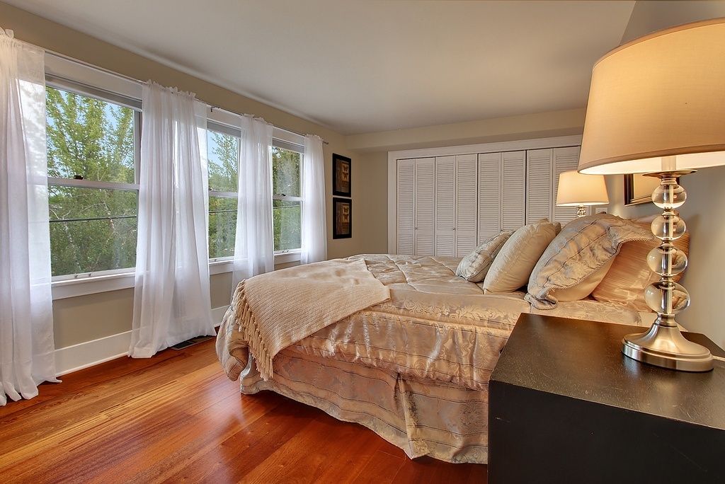 Modern Guest Bedroom with Standard height, double-hung window, Hardwood floors