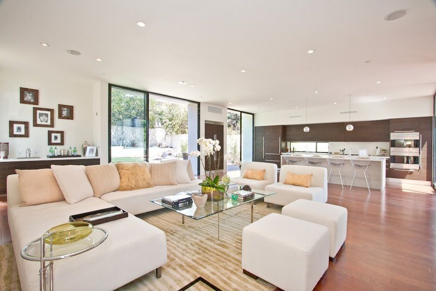 Contemporary Great Room with Standard height, Built-in bookshelf, can lights, specialty window, Carpet, Laminate floors