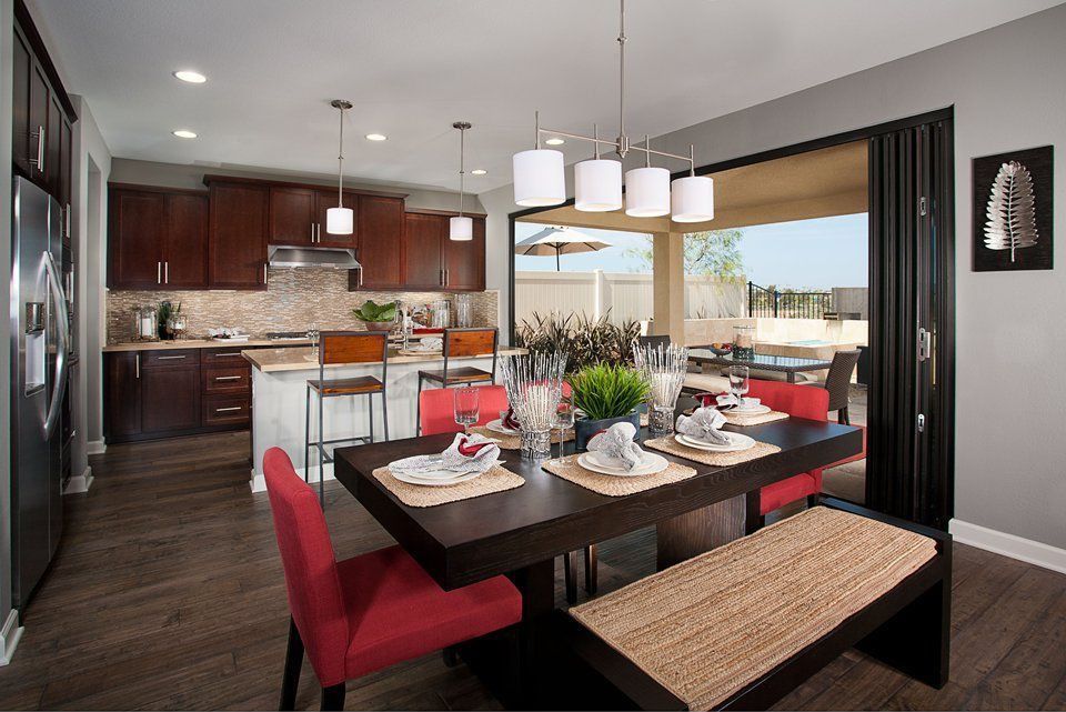 Modern Kitchen with Laminate floors, Built In Refrigerator, Kitchen island, Flat panel cabinets, Framed Partial Panel