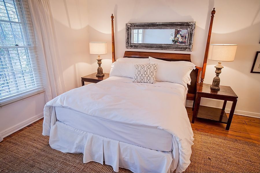 Contemporary Guest Bedroom with double-hung window, Standard height, Hardwood floors, specialty window