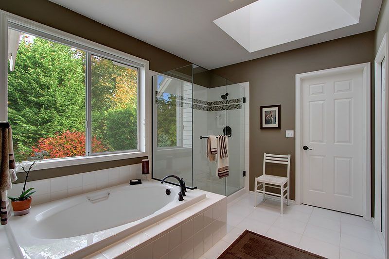 Traditional Master Bathroom with Master bathroom, drop in bathtub, Shower, stone tile floors, Bathtub, Standard height