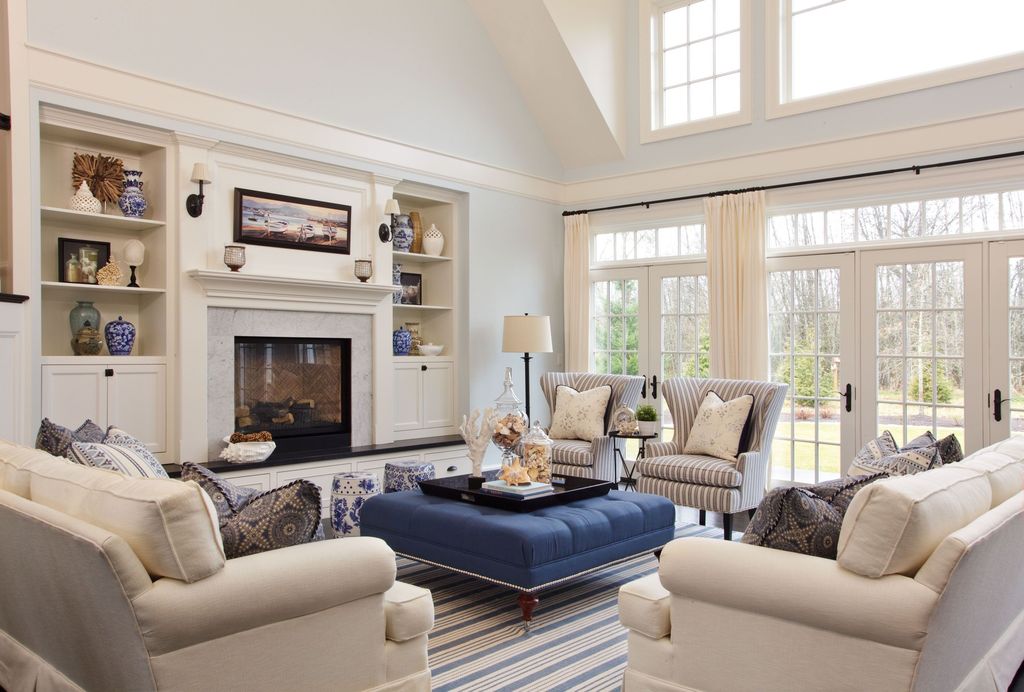 Traditional Living Room with Cement fireplace, Z Gallerie Tufted Ottoman - Sapphire, Wall sconce, French doors, Crown molding