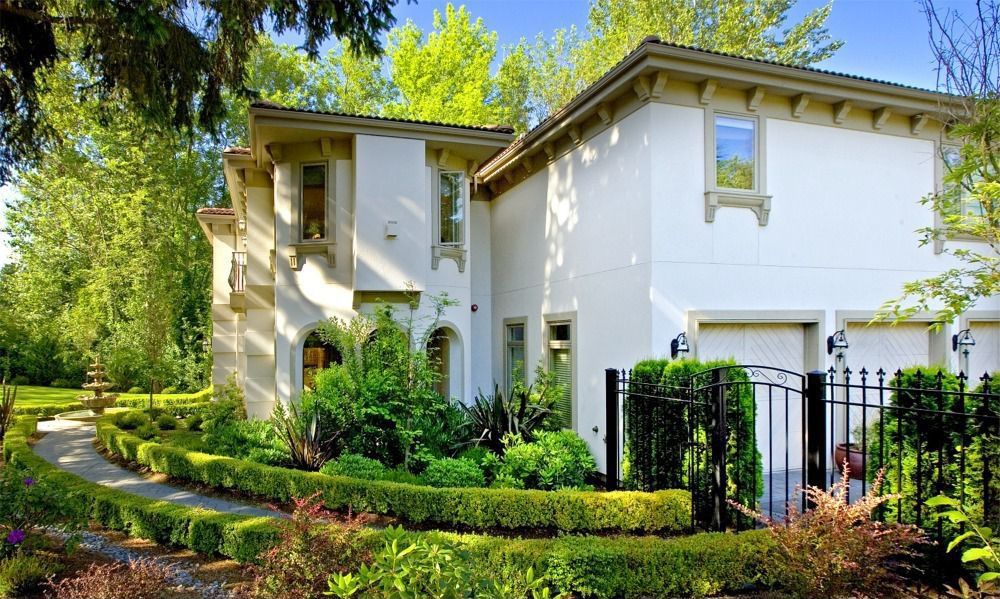 Mediterranean Front of Home with Gate, picture window, Fence, Pathway, exterior stone floors, Fountain, specialty window