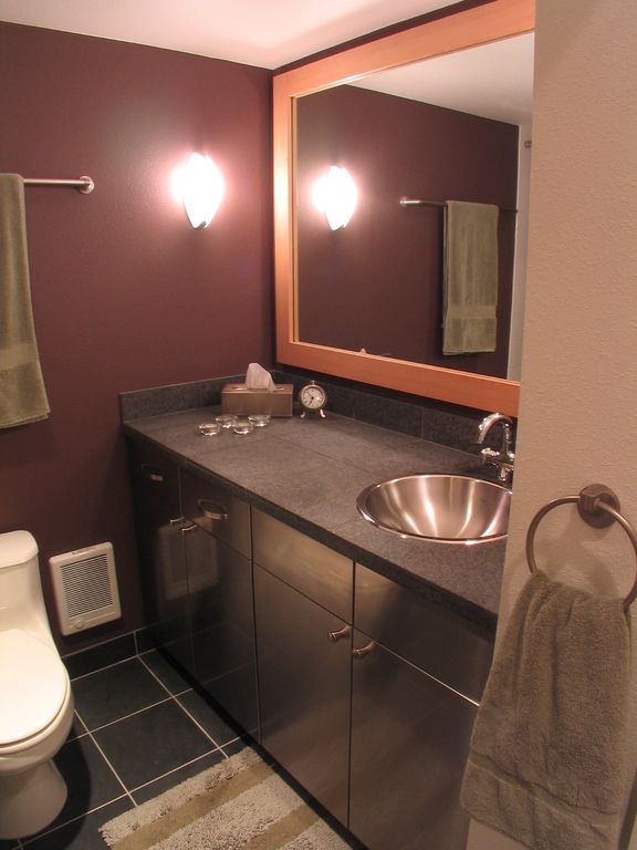 Full Bathroom with Stone Tile, European Cabinets, Drop-in sink, Paint, Wall sconce, Simple granite counters, Flush, Full Bath