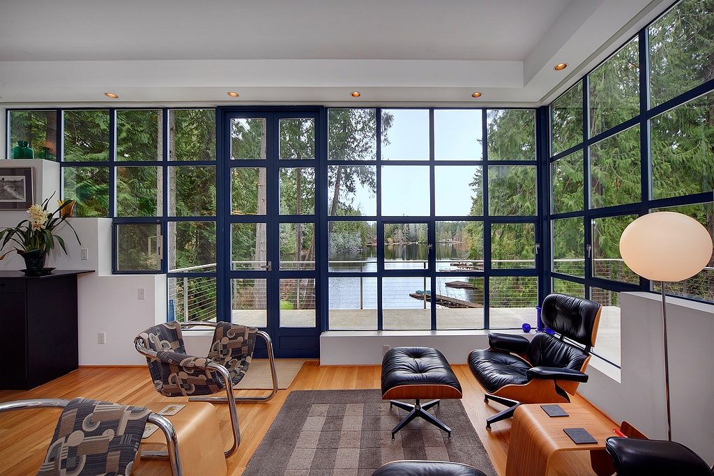 Contemporary Living Room with Eames lounge chair and ottoman, Hardwood floors, Offi Mag Table, Glo-Ball F3 Floor Lamp