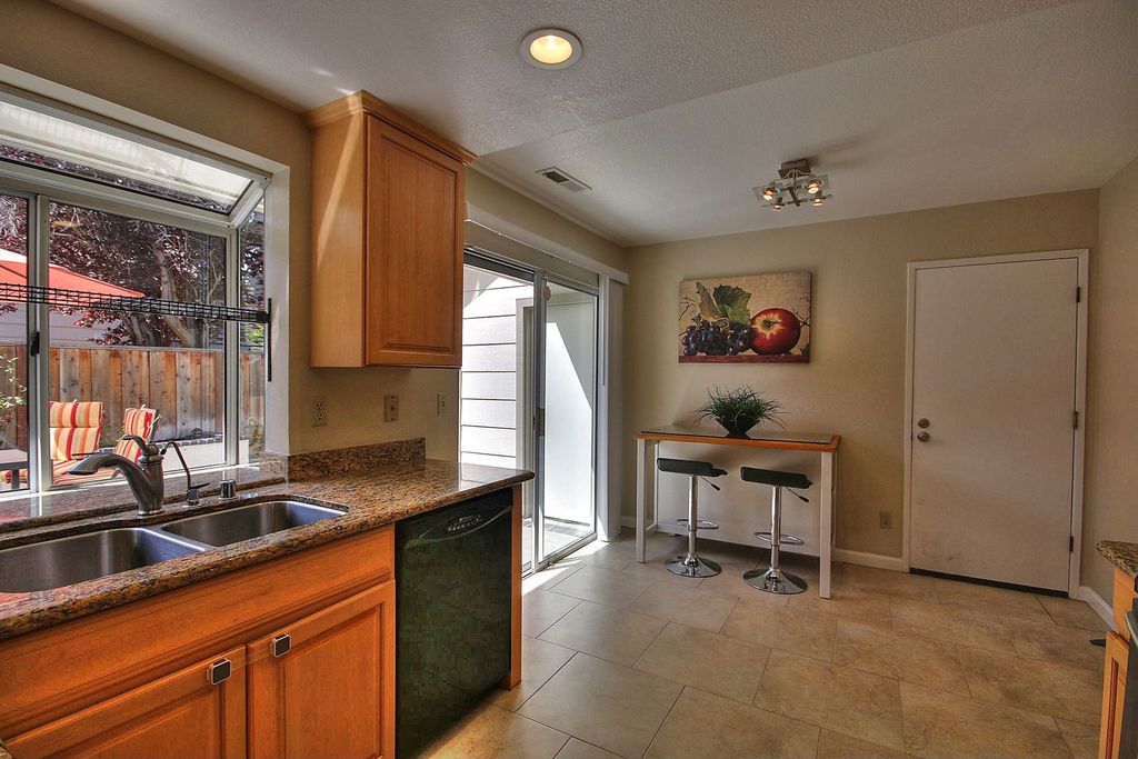 Craftsman Kitchen with Multiple Sinks, Lumisource ale barstool black, Paint 1, flat door, stone tile floors, Complex Granite