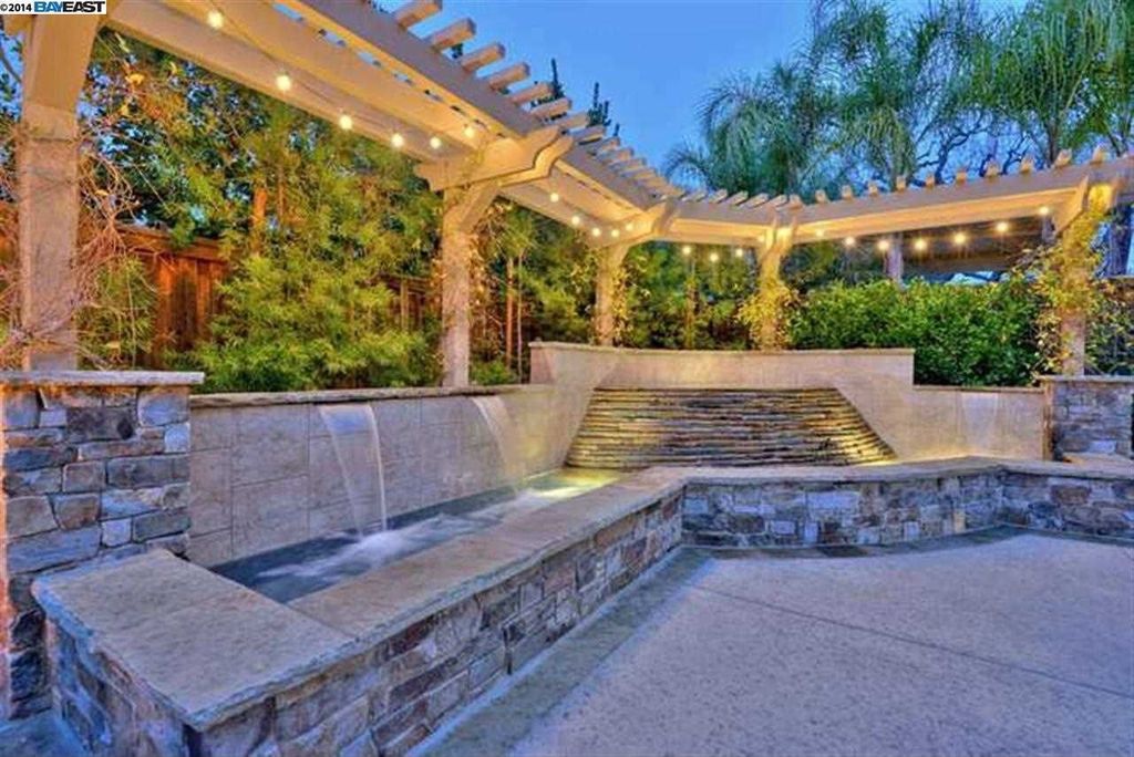 Traditional Landscape/Yard with exterior tile floors, Fountain, exterior concrete tile floors, Trellis, Fence
