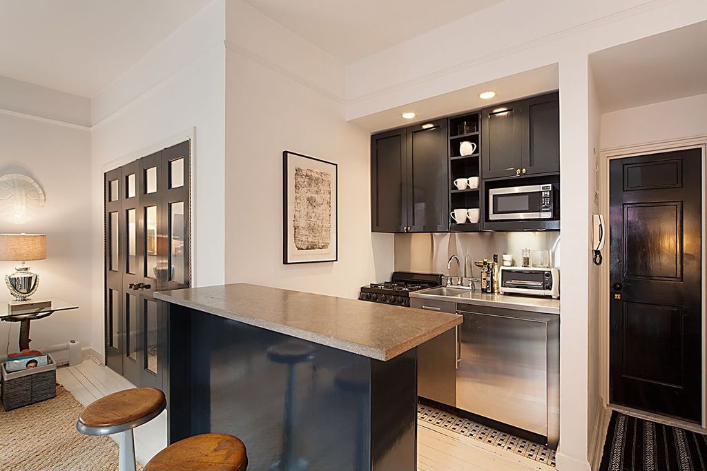 Contemporary Kitchen with Flat panel cabinets, can lights, full backsplash, gas range, Concrete counters, specialty door