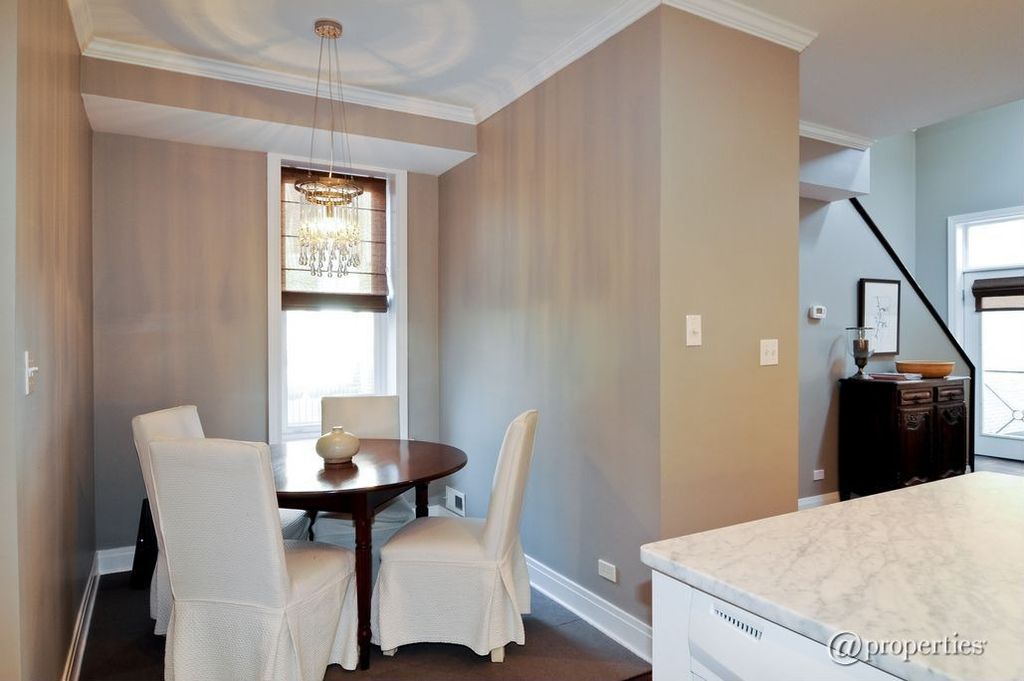 Contemporary Dining Room with Standard height, Carpet, Chandelier, Crown molding, double-hung window, Hardwood floors