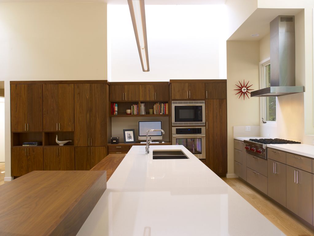 Contemporary Kitchen with Stainless undermount 2-basin sink, full backsplash, george nelson sunburst clock red, Pendant light