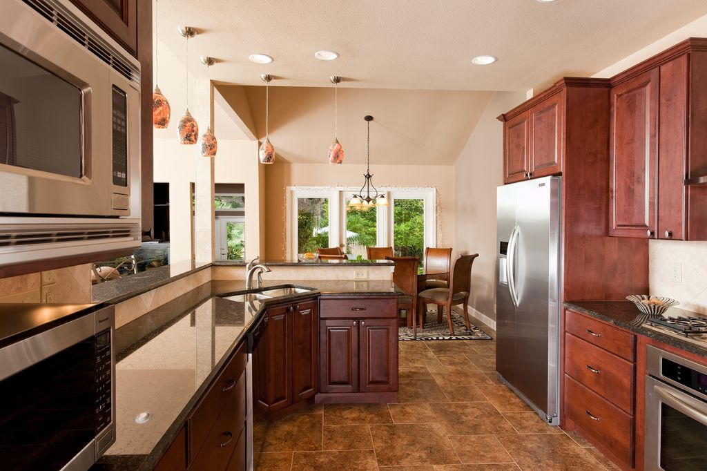Traditional Kitchen with French doors, Multiple Sinks, Wall Hood, full backsplash, electric cooktop, Breakfast bar, U-shaped