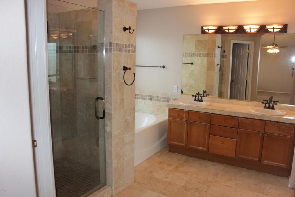 Traditional Master Bathroom with Limestone Tile, European Cabinets, Double sink, stone tile counters, Wall Tiles, Bathtub