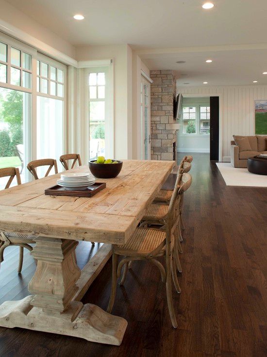 Country Dining Room with stone fireplace, Hardwood floors, French doors, Standard height, Paint 1, specialty window