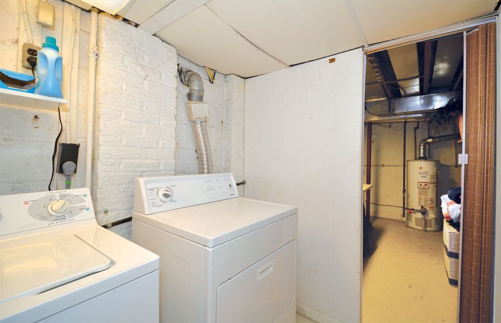 Traditional Laundry Room with Undermount sink, laundry sink, Built-in bookshelf, Concrete floors, Standard height
