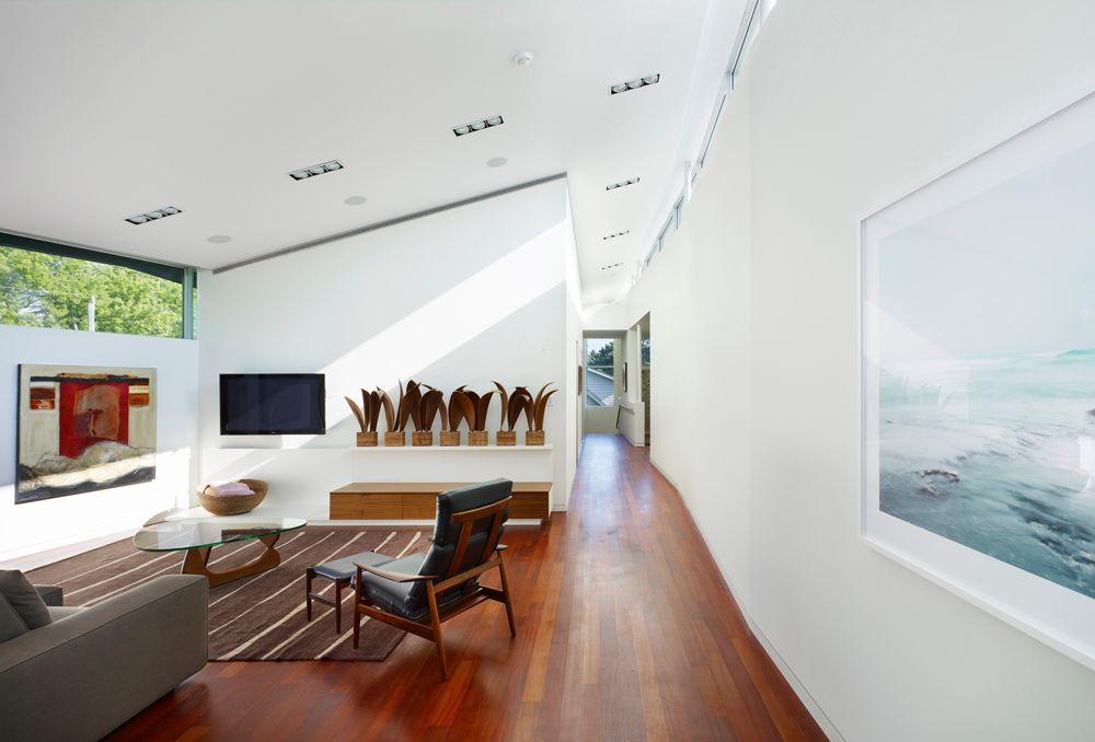 Modern Living Room with Surya dominican area rug 8'x11', Hardwood floors, Paint 1, can lights, picture window, High ceiling
