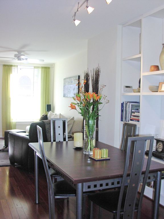 Contemporary Dining Room with Built-in bookshelf, Hardwood floors, flush light, Standard height