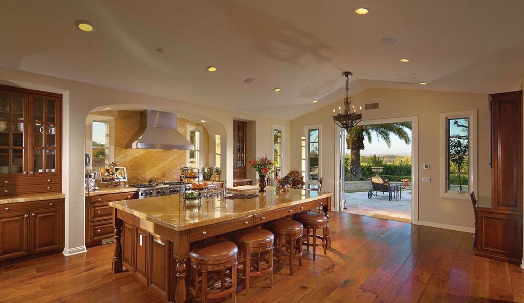 Traditional Kitchen with Chandelier, Breakfast nook, High ceiling, full backsplash, One-wall, double oven range, Wall Hood