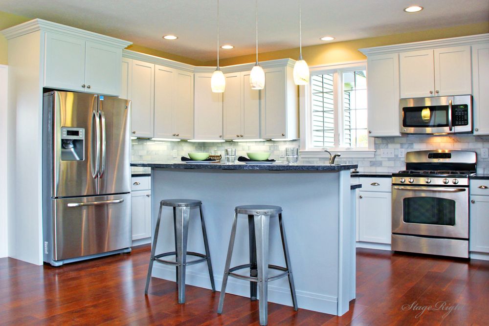 Traditional Kitchen with Breakfast bar, European Cabinets, gas range, Soapstone counters, Pendant light, Standard height