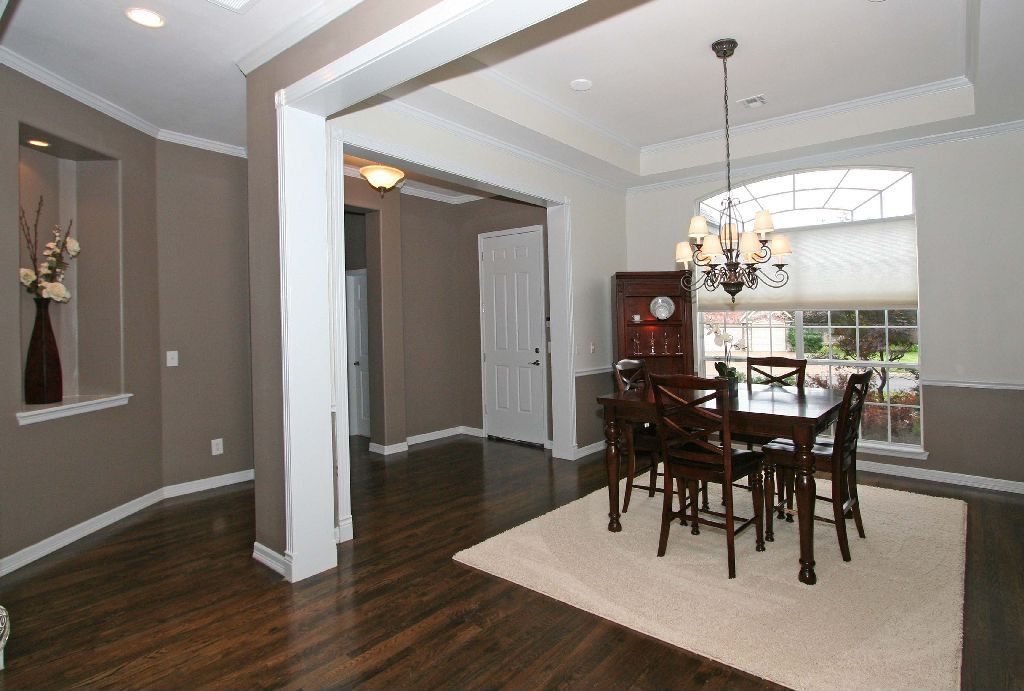 Traditional Dining Room with Standard height, Chandelier, Chair rail, Crown molding, Hardwood floors, Casement