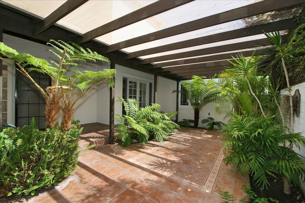 Mediterranean Landscape/Yard with exterior tile floors, French doors, Casement, Stained glass window, Fence